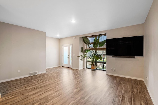 217 N Van Buren St, Green Bay, WI 54301 - unfurnished living room with wood finished floors and recessed lighting