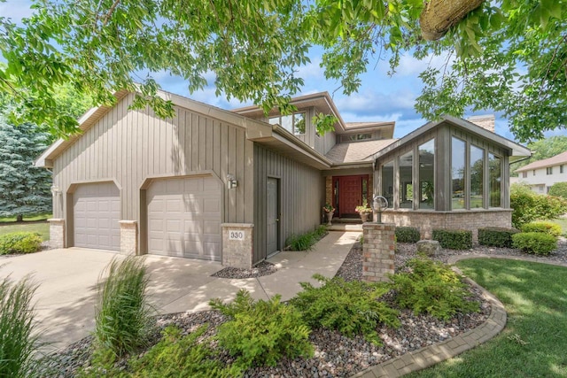 330 W Florida Ave, Appleton, WI 54911 - mid-century modern home with concrete driveway, a garage, and a sunroom