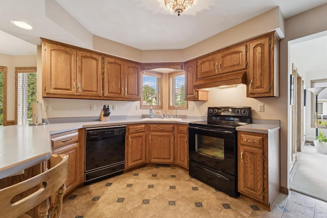 330 W Florida Ave, Appleton, WI 54911 - kitchen with black appliances, premium range hood, light countertops, and healthy amount of natural light