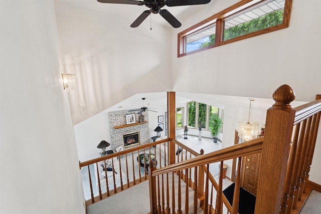 330 W Florida Ave, Appleton, WI 54911 - stairway featuring ceiling fan, plenty of natural light, a fireplace, a towering ceiling, and carpet floors