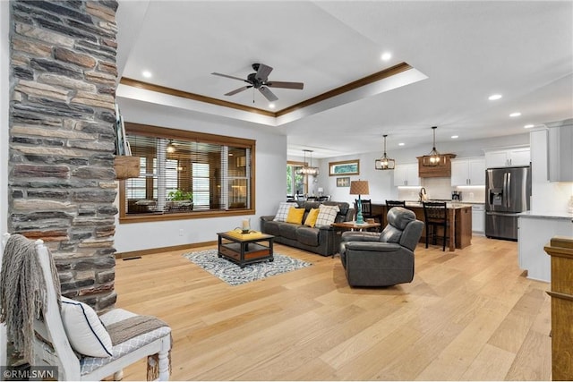 3735 Crest Ridge Ct, Eau Claire, WI 54701 - living area with a tray ceiling, ornamental molding, light wood-type flooring, a ceiling fan, and recessed lighting