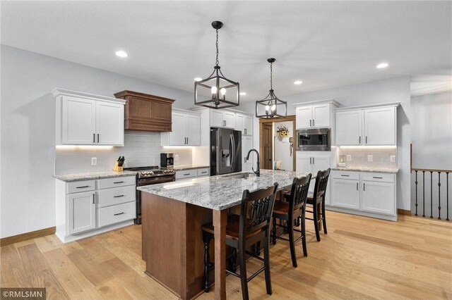 3735 Crest Ridge Ct, Eau Claire, WI 54701 - kitchen featuring stainless steel appliances, backsplash, white cabinetry, light wood-style flooring, and recessed lighting