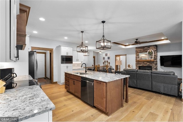 3735 Crest Ridge Ct, Eau Claire, WI 54701 - kitchen with stainless steel appliances, ceiling fan, white cabinetry, a fireplace, and light wood finished floors