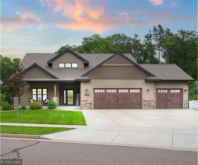 3735 Crest Ridge Ct, Eau Claire, WI 54701 - craftsman-style house featuring an attached garage, stone siding, a front lawn, and concrete driveway