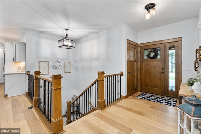3735 Crest Ridge Ct, Eau Claire, WI 54701 - entryway with light wood-type flooring and a chandelier