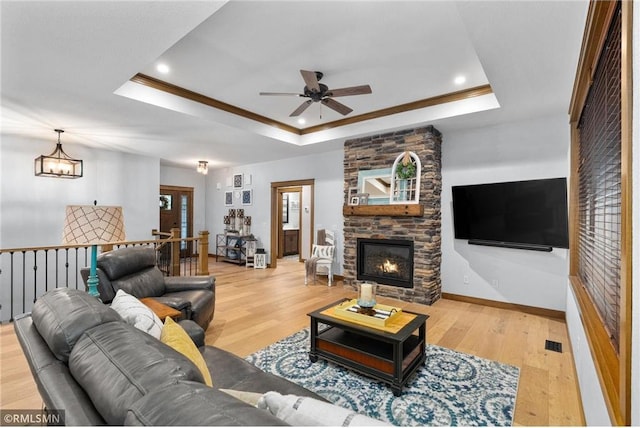 3735 Crest Ridge Ct, Eau Claire, WI 54701 - living room featuring a ceiling fan, a raised ceiling, wood finished floors, a fireplace, and recessed lighting
