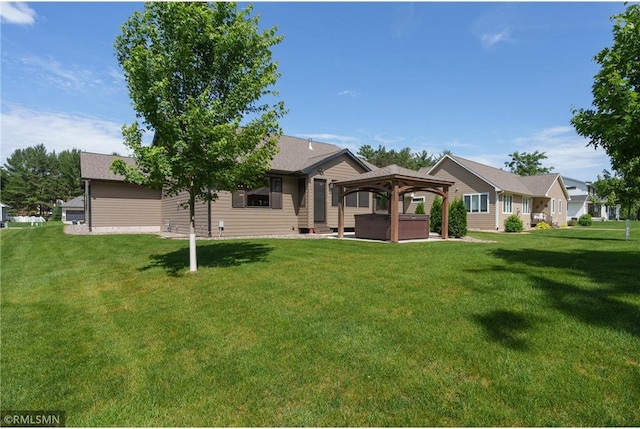 3735 Crest Ridge Ct, Eau Claire, WI 54701 - back of property featuring a hot tub, a gazebo, and a yard