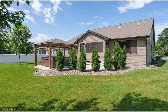 3735 Crest Ridge Ct, Eau Claire, WI 54701 - back of property with a hot tub, a gazebo, roof with shingles, and a patio