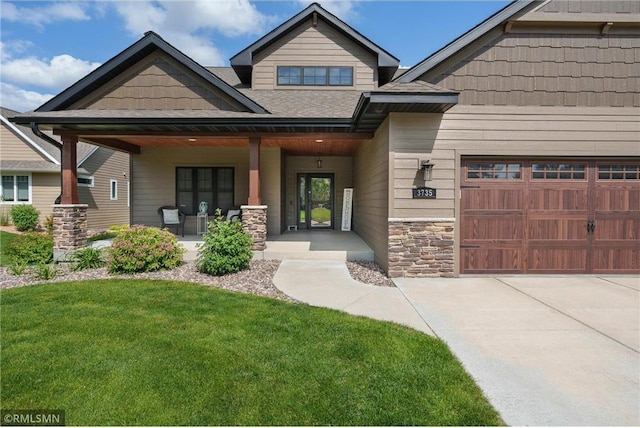 3735 Crest Ridge Ct, Eau Claire, WI 54701 - craftsman house featuring a porch, stone siding, a front lawn, an attached garage, and driveway