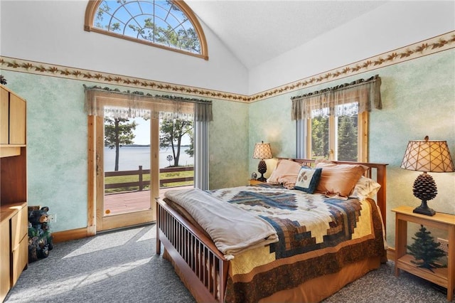 2282 71st St, Luck, WI 54853 - bedroom featuring access to exterior, multiple windows, a water view, carpet flooring, and high vaulted ceiling
