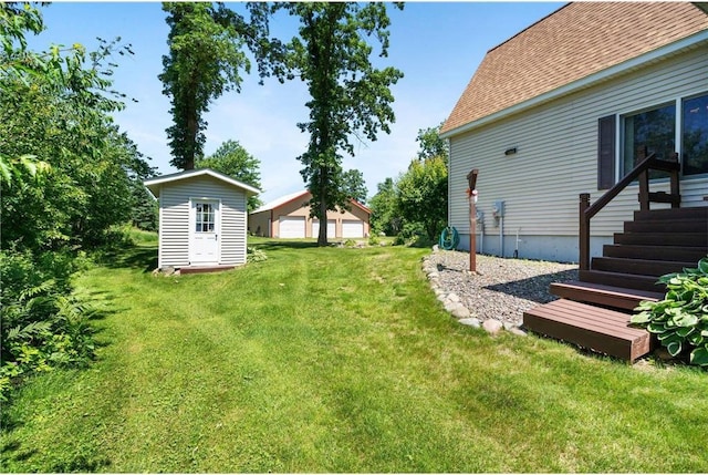 2282 71st St, Luck, WI 54853 - view of grassy yard with an outbuilding and a garage
