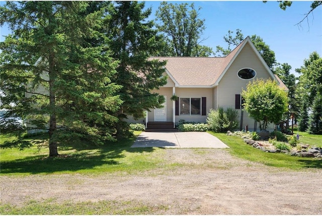 2282 71st St, Luck, WI 54853 - view of front of property featuring dirt driveway, a front yard, and a shingled roof