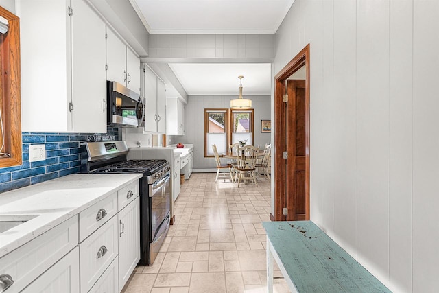 1515 Rugby St, Oshkosh, WI 54902 - kitchen with stainless steel appliances, white cabinets, decorative backsplash, crown molding, and light stone counters