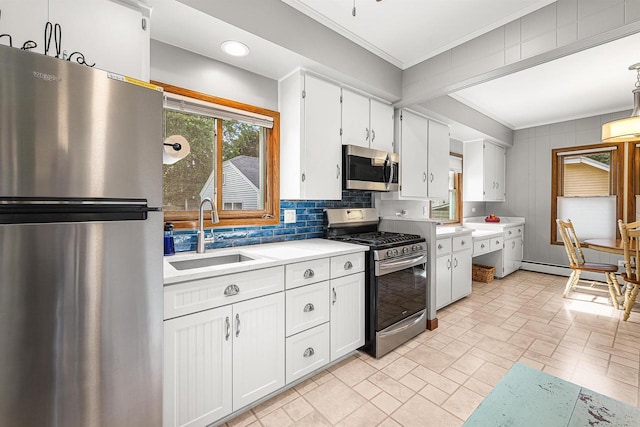 1515 Rugby St, Oshkosh, WI 54902 - kitchen with appliances with stainless steel finishes, ornamental molding, light countertops, white cabinets, and tasteful backsplash