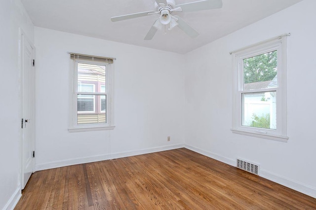 415 Broadway Ave, Wausau, WI 54403 - unfurnished room with healthy amount of natural light, wood finished floors, and a ceiling fan