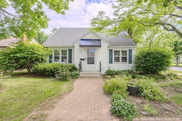 415 Broadway Ave, Wausau, WI 54403 - view of front of house with roof with shingles and a chimney