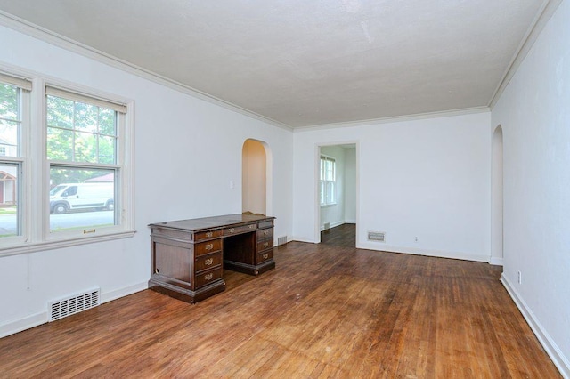 415 Broadway Ave, Wausau, WI 54403 - unfurnished living room featuring arched walkways, wood finished floors, and ornamental molding