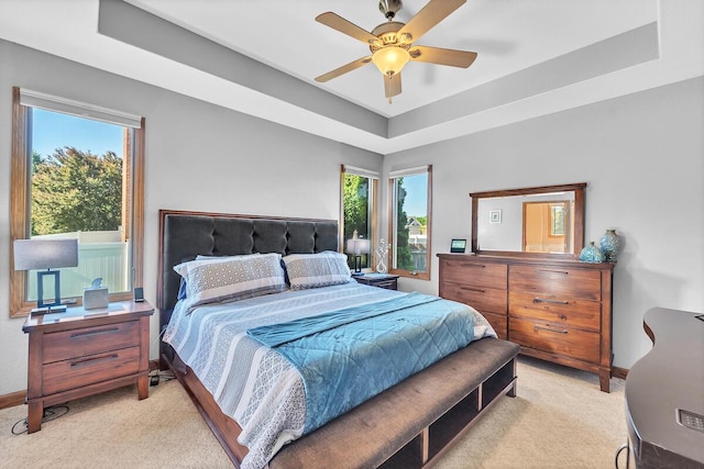 8668 47th Ave, Kenosha, WI 53142 - bedroom with light carpet, a tray ceiling, and ceiling fan