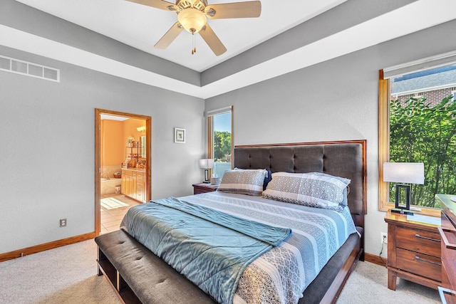 8668 47th Ave, Kenosha, WI 53142 - bedroom featuring multiple windows, light carpet, ensuite bath, and a ceiling fan