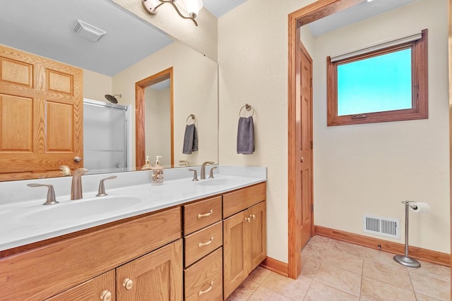 8668 47th Ave, Kenosha, WI 53142 - bathroom with double vanity, a shower stall, and tile patterned floors