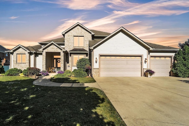 8668 47th Ave, Kenosha, WI 53142 - view of front of house with a garage, concrete driveway, brick siding, a front lawn, and a shingled roof