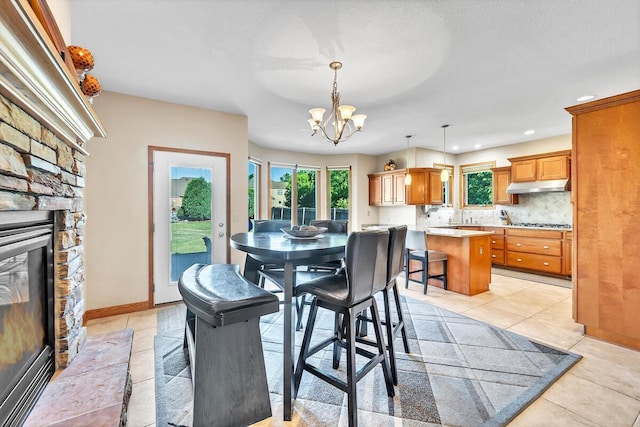 8668 47th Ave, Kenosha, WI 53142 - dining space featuring a fireplace, healthy amount of natural light, light tile patterned floors, and recessed lighting