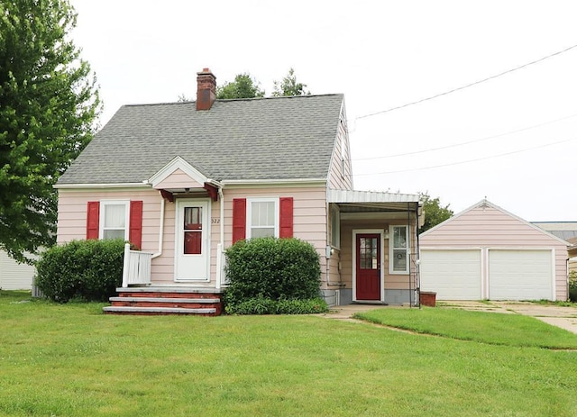 322 E N Ave, Little Chute, WI 54140 - cape cod home featuring an outdoor structure, a front yard, a detached garage, a chimney, and a shingled roof