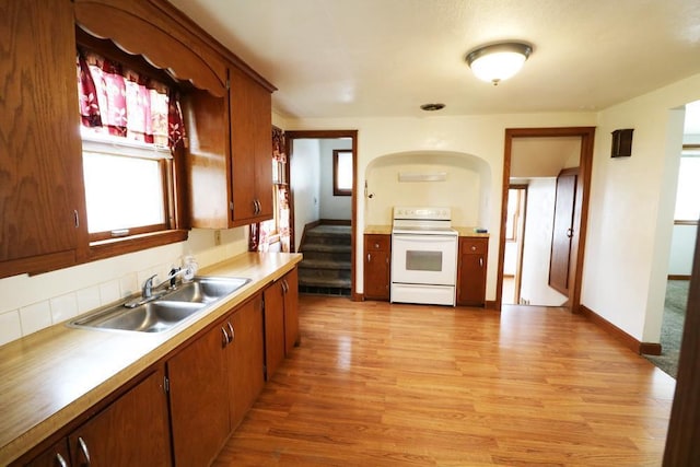 322 E N Ave, Little Chute, WI 54140 - kitchen featuring white range with electric cooktop, light wood-style flooring, light countertops, and brown cabinetry