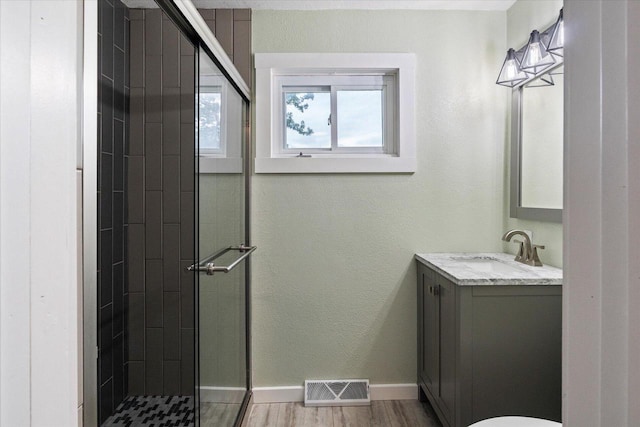 624 S Main St, Westby, WI 54667 - full bath with a shower stall, vanity, and wood finished floors