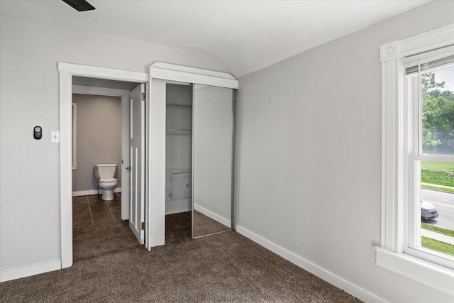 624 S Main St, Westby, WI 54667 - unfurnished bedroom with dark colored carpet, a closet, connected bathroom, and lofted ceiling