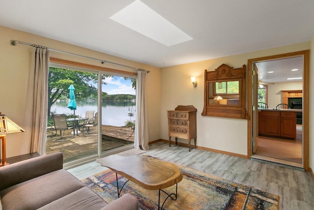 S7663 W Grandview Ave, Merrimac, WI 53561 - living area with a skylight, light wood finished floors, a water view, and a fireplace