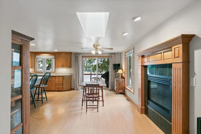 S7663 W Grandview Ave, Merrimac, WI 53561 - kitchen featuring light wood-style flooring, recessed lighting, a ceiling fan, a fireplace, and light countertops