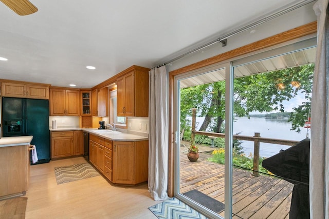 S7663 W Grandview Ave, Merrimac, WI 53561 - kitchen with black appliances, light countertops, light wood-type flooring, recessed lighting, and a water view