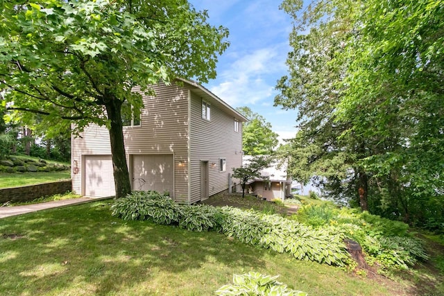 S7663 W Grandview Ave, Merrimac, WI 53561 - view of side of property featuring a garage and a lawn