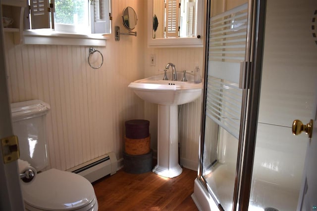 22630 Elm St, Cornucopia, WI 54827 - bathroom with a baseboard heating unit, a stall shower, and wood finished floors