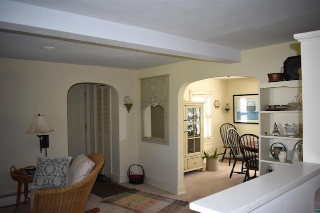 22630 Elm St, Cornucopia, WI 54827 - carpeted living room with arched walkways and a baseboard heating unit