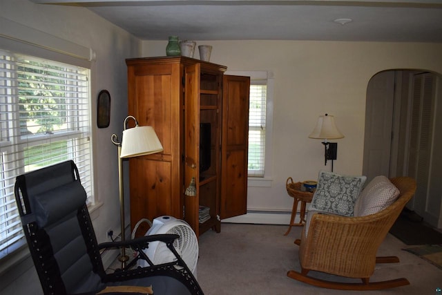 22630 Elm St, Cornucopia, WI 54827 - sitting room featuring a baseboard heating unit, carpet, and arched walkways