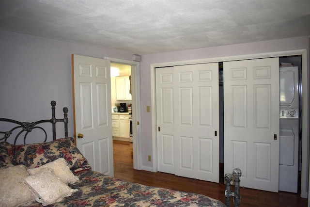 22630 Elm St, Cornucopia, WI 54827 - bedroom with estacked washer and dryer, dark wood finished floors, and a closet