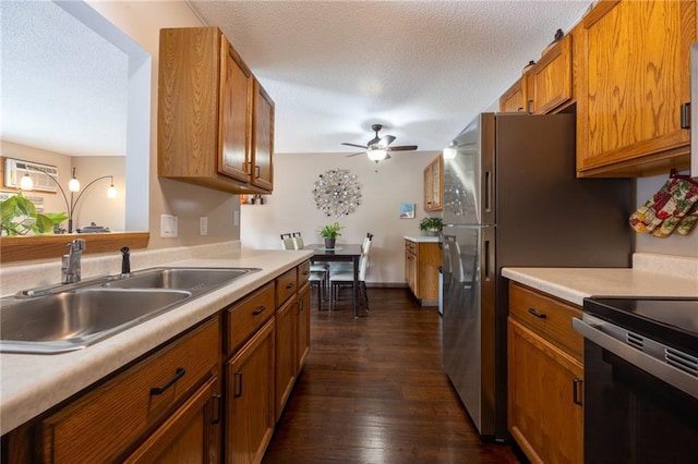 3950 Boardwalk St, Eau Claire, WI 54701 - kitchen with range with electric cooktop, brown cabinets, light countertops, dark wood-type flooring, and ceiling fan