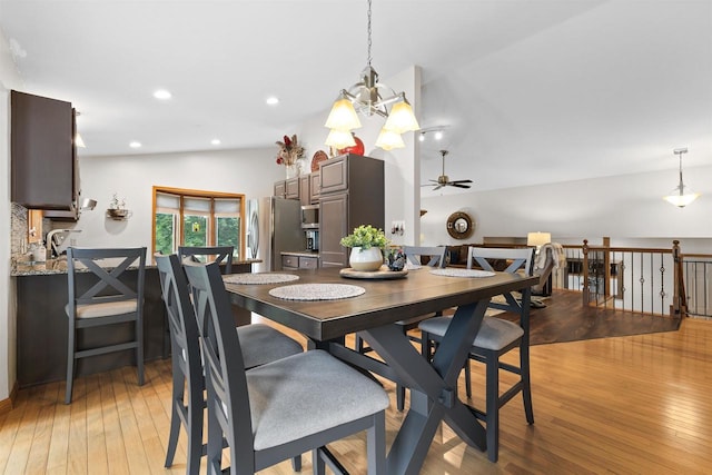 2570 Country Meadow Ct, Green Bay, WI 54313 - dining space featuring lofted ceiling, ceiling fan, light wood finished floors, and a chandelier
