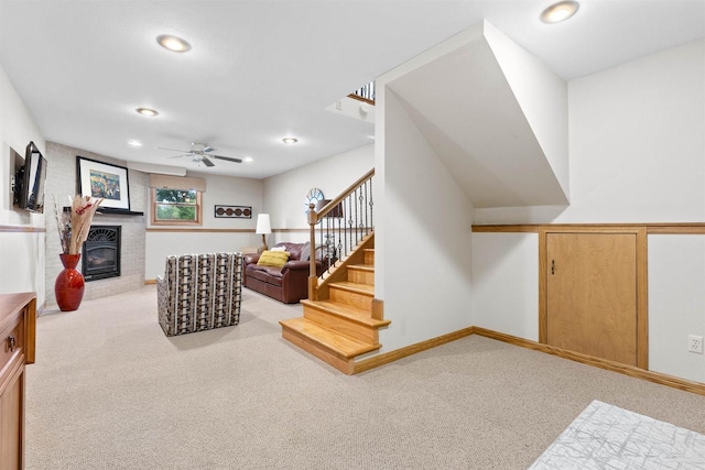 2570 Country Meadow Ct, Green Bay, WI 54313 - living room featuring light colored carpet, stairs, ceiling fan, recessed lighting, and a fireplace