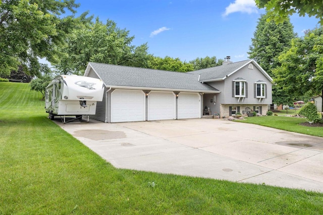 2570 Country Meadow Ct, Green Bay, WI 54313 - tri-level home featuring a garage, driveway, a chimney, a front yard, and roof with shingles