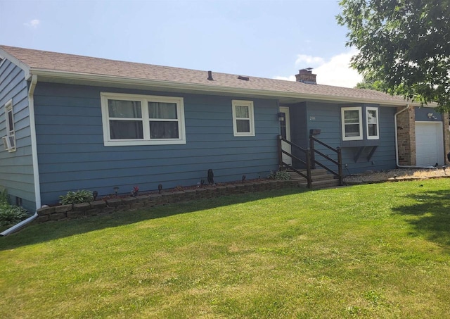 201 Chestnut Dr, Elroy, WI 53929 - view of front facade with a chimney, an attached garage, and a front yard