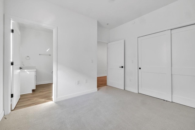 9352 S Alder Pl Unit 104, Oak Creek, WI 53154 - unfurnished bedroom with light carpet and a closet