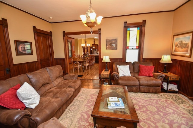 823 E Brandybrook Rd, Wales, WI 53183 - living area with a chandelier, wainscoting, wooden walls, wood finished floors, and crown molding