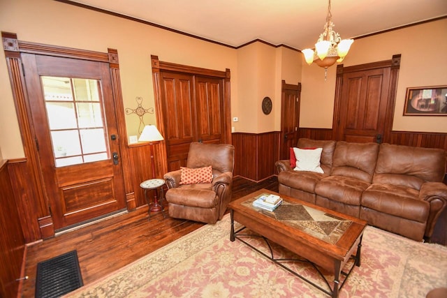 823 E Brandybrook Rd, Wales, WI 53183 - living area featuring wood finished floors, wood walls, a wainscoted wall, crown molding, and a chandelier