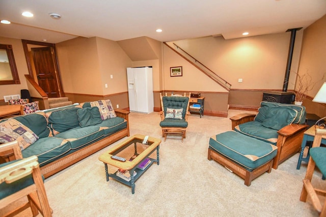 823 E Brandybrook Rd, Wales, WI 53183 - carpeted living area featuring recessed lighting, stairs, and a wood stove