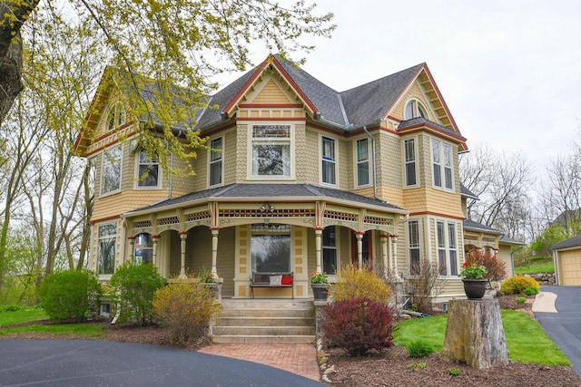 823 E Brandybrook Rd, Wales, WI 53183 - victorian house with a porch and roof with shingles