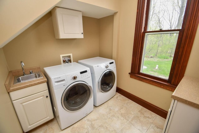 823 E Brandybrook Rd, Wales, WI 53183 - laundry room featuring washing machine and clothes dryer, cabinet space, and healthy amount of natural light