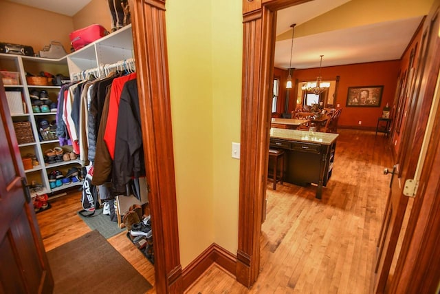 823 E Brandybrook Rd, Wales, WI 53183 - walk in closet featuring a chandelier, wood finished floors, and lofted ceiling